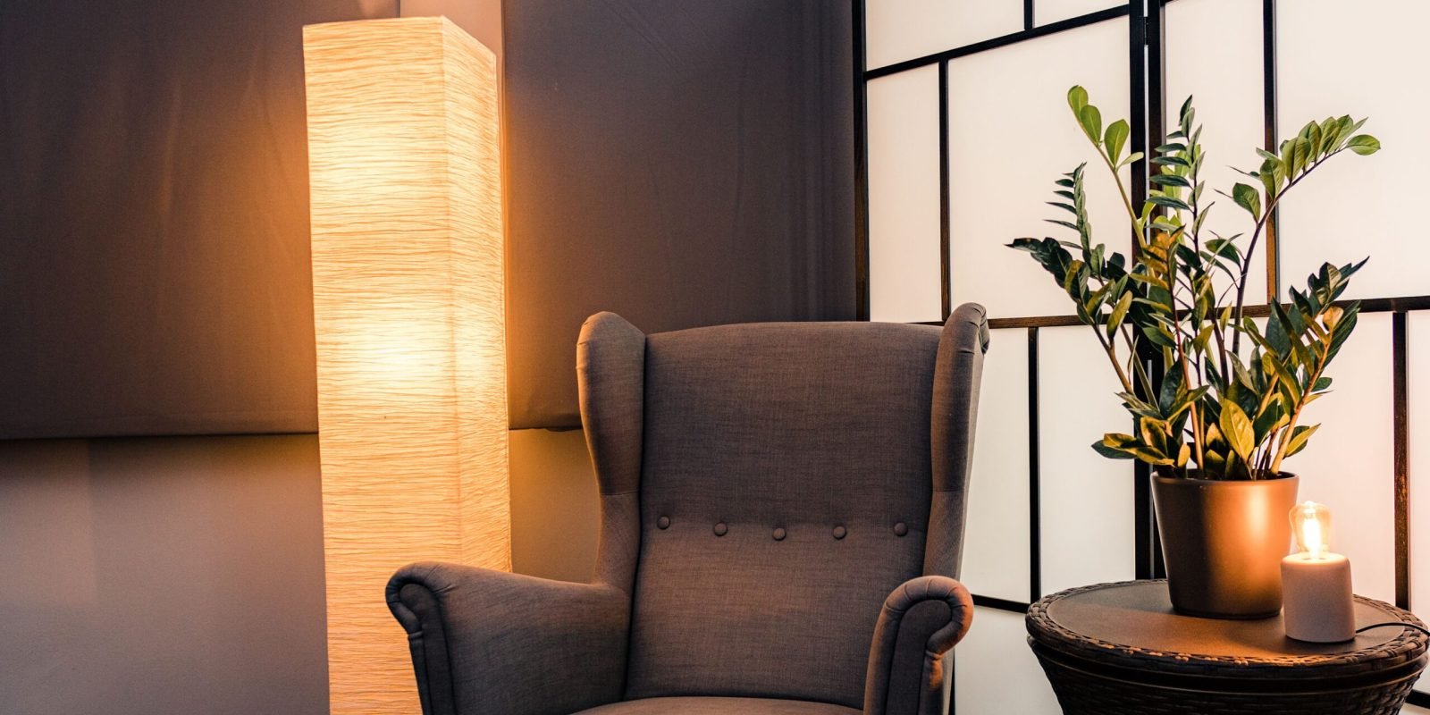 Inviting armchair with glowing floor lamp in a stylish interior setting in Budapest.
